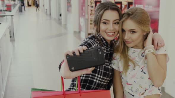Cute Women Doing Selfies with Surprised and Happy Faces in Shopping Center alt