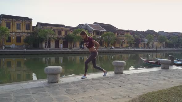 Aerial View Young Woman Does Morning Excercises at River alt