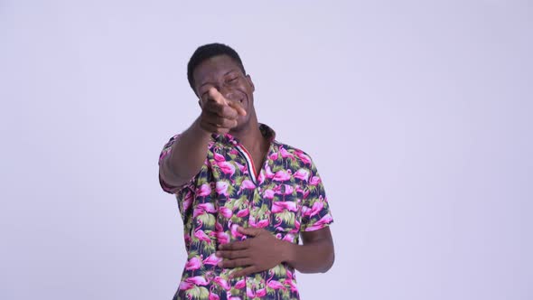 Young Happy African Tourist Man Laughing and Pointing at Camera alt