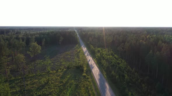 Drone Footage of Highway in The Middle of A Green Forest 