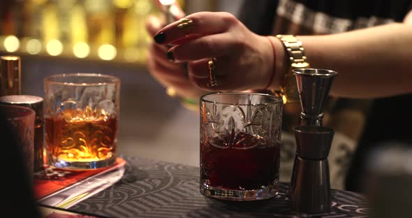 The Bartender Prepares a Cocktail and Sprays the Flavoring alt