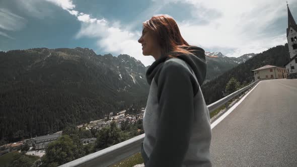 Slow Motion Shot of Happy Young Woman Spinning and Running in the Dolomites Northern Italy in the alt