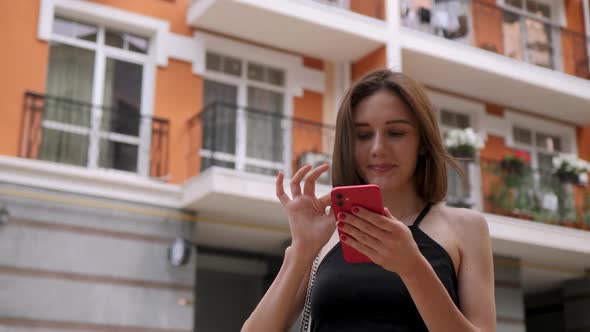 Cute Girl Use Red Smartphone Outdoor