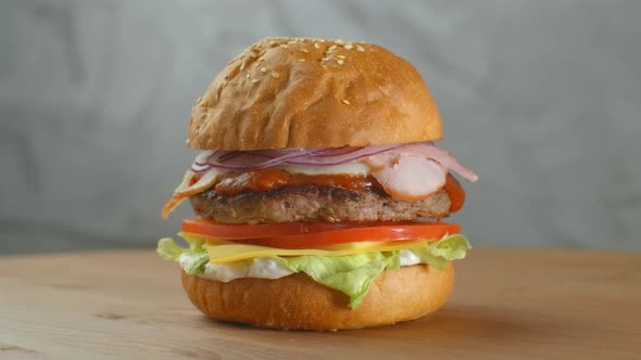 A Delicious Cheeseburger Served on a Wooden Platter alt