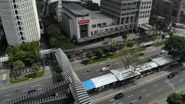 Cinematic aerial view of cityscape and crossing bridge with road traffic