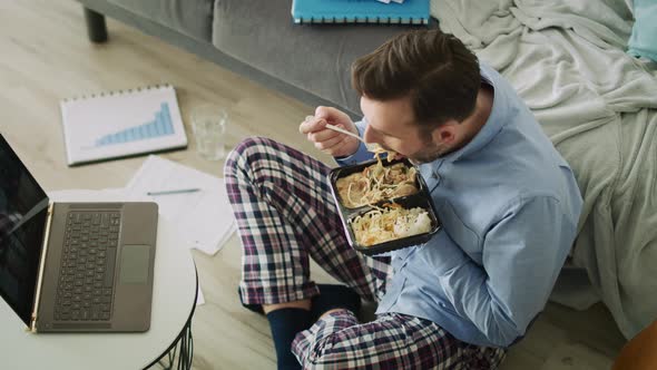 Video from the top of man while video conference. Shot with RED helium camera in 8K alt