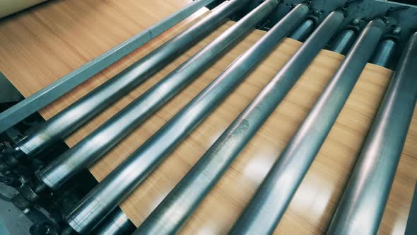 Facing Material Is Being Moved By the Rolling Conveyor alt