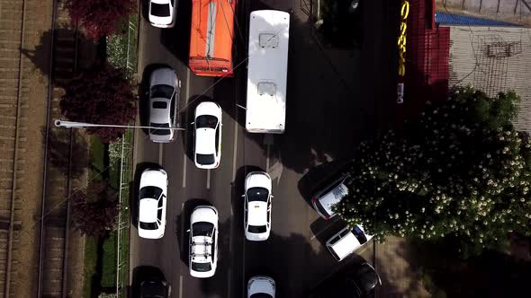 Top Down Street View of Freeway Busy City Rush Hour Heavy Traffic Jam Highway and Tram Way. alt