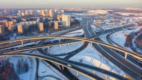 Road Junction and Cars Traffic at Sunny Winter Evening in Urban City. Aerial View alt