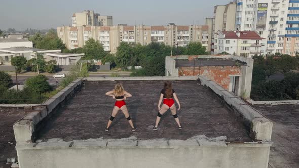 Two Girls Dance Twerk on the Roof of an Abandoned Building