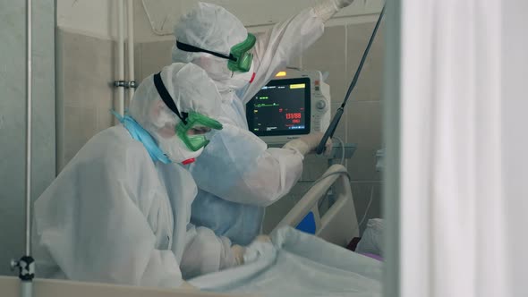 Doctors in Covid19 Protection Suits Are Helping a Patient with Coronavirus alt