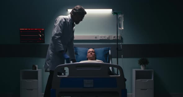 Medical Practitioner Covering Dead Patient with Blanket alt