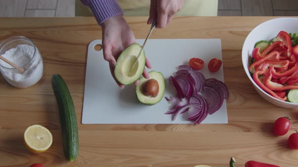 Woman Is Cutting Avocado for Snack