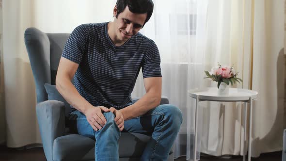 A Man Stroking Painful Knee alt
