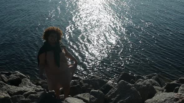Happy Plus Size African Black Woman Afro Hair Outdoor Enjoying Evening Seaside Holiday at Sunset