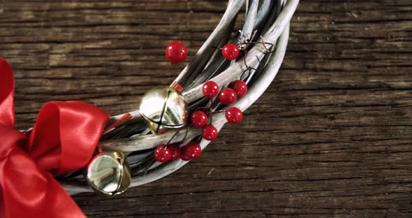 Grapevine wreath with ribbon on wooden table 4k alt