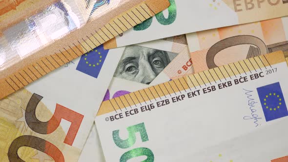 Partly View of 100 Dollars Bill From Under Euro Banknotes alt