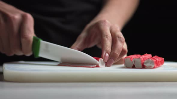 Female Hands Make Salad of Crab Sticks Cucumber Corn Eggs in the Kitchen at Home alt