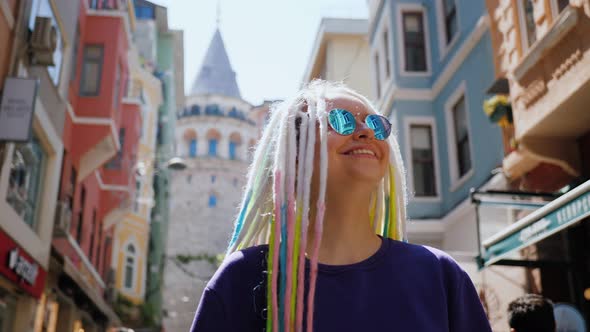 Portrait Woman with Sunglasses and Dreadlocks Walking Street Near Galata Tower alt