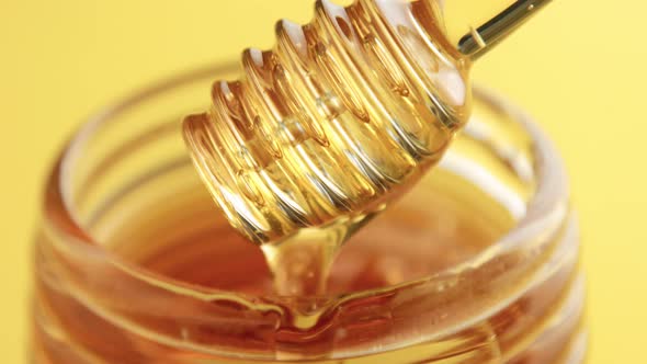 Closeup of Honey Spoon with Pouring Honey