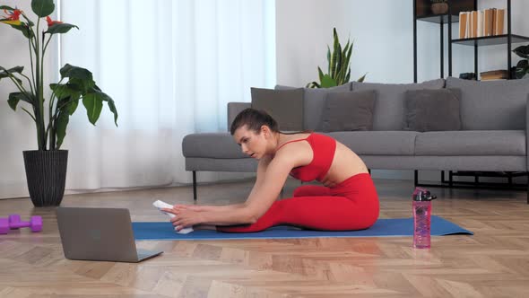 Fit Woman Doing Warmup Stretching Exercise on Yoga or Fitness Blue Mat at Home alt