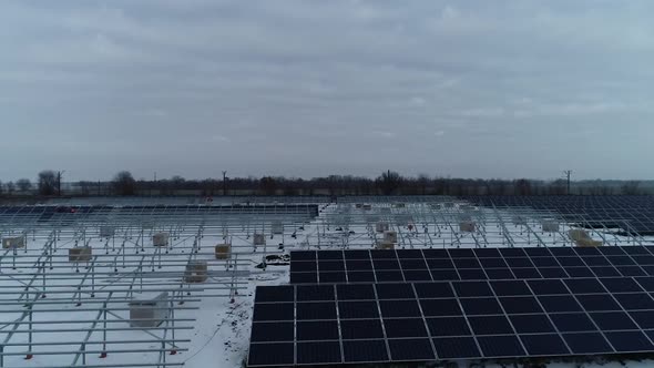 Aerial View of a Construction Site of a Solar Power Station in Winter alt