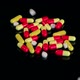 Closeup of Many White Pills Falling on Black Table - VideoHive Item for Sale