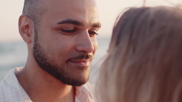 Young Couple in Love Looking at Each Other at the Beach