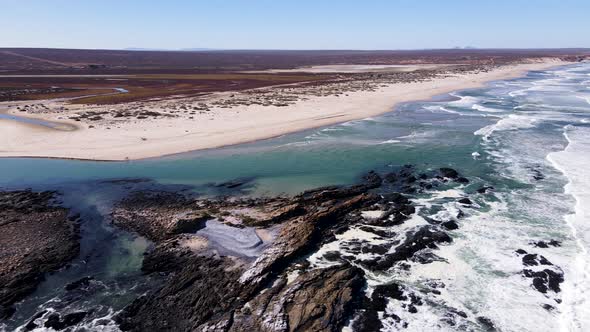 Remote beach and jagged west coast shoreline at Olifants River Estuary; drone alt