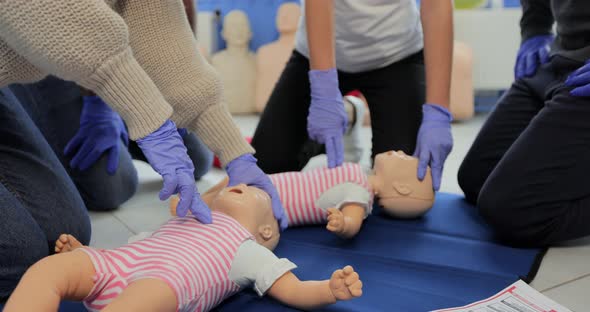Close Up of Group of Multiethnic People During the First Aid Training with Instructor Showing on alt