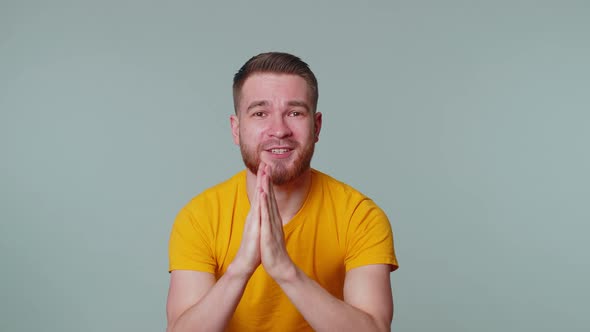 Trendy Young Adult Man Praying Looking Upward and Making Wish Asking God for Help Begging Apology alt
