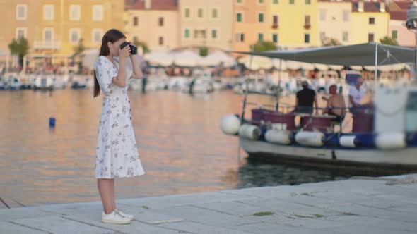 Woman Tourist is Photographing Port of Rovinj City in Croatia alt