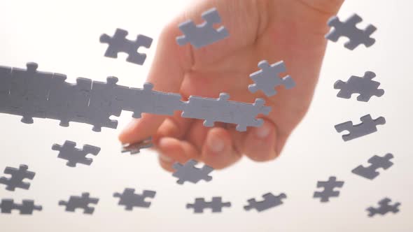 Puzzle Pieces and Hands of Closeup. Task and Subtask Concept. Pastime, a Hobby. Teamwork Concept alt