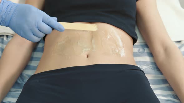 The Doctor Lubricates the Patient's Body with Gel for Further Medical Examination alt