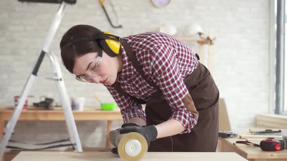 Close Up Professional Carpenter Woman in Charge of Polishing the Wooden Tableslow Mo alt