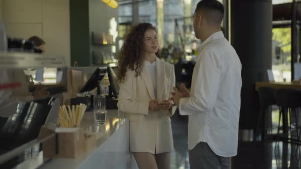 Gorgeous Young Businesswoman Talking with Colleague in Cafe Waiting for Coffee. Portrait of alt