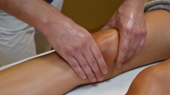 Woman Getting Legs Massage in Spa Salon