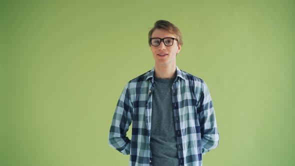 Portrait of Attractive Male Student Looking at Camera Winking and Smiling alt
