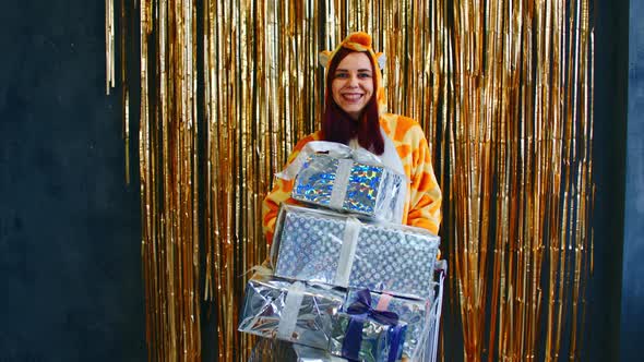 Happy Woman with Trolley with Christmas Presents and Baubles alt