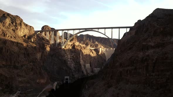 4K Aerial View of Hoover Dam and Colorado River Bypass Bridge from down in the Colorado River gorge