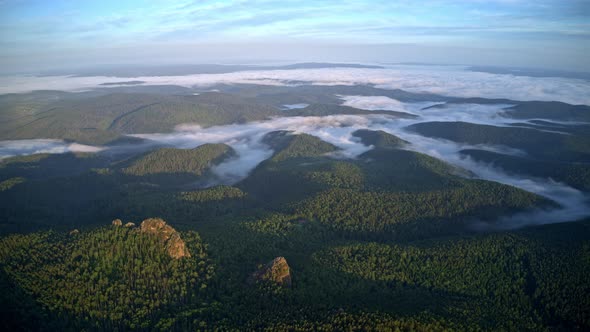 Top View of the Mountains in the Fog in the Russian Nature Reserve Stolby alt