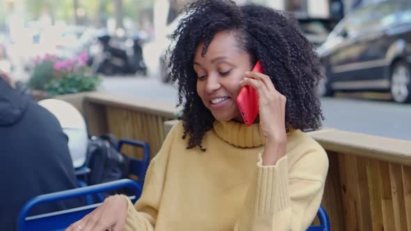 Brazilian Cheerful Young Woman Talking on the Phone on a Terrace alt