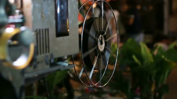 Film runs through a 35mm projector in a movie theater