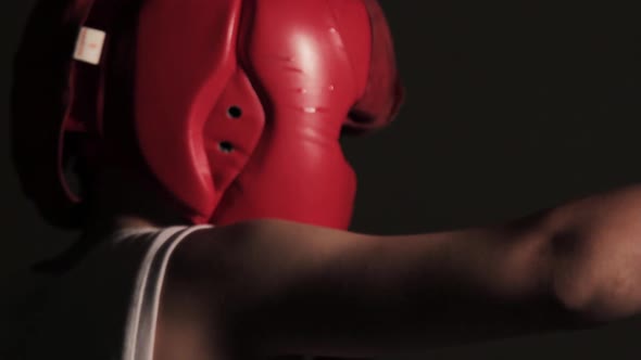 Guy boxer beats his fists in the air while training for a fight. Young man boxing with shadow closeu