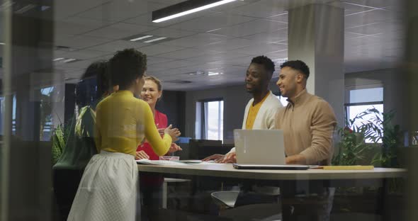 Happy diverse male and female business colleagues teaming up in office alt