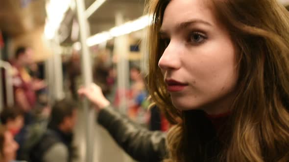 Young beautiful caucasian woman commuter in the subway alt