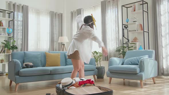 Funny Asian Woman Wearing Scuba Diver Mask And Swim In The Air Near Suitcases - Traveling alt