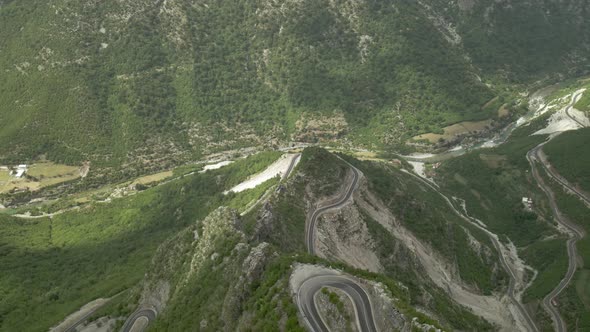 Aerial View of Dangerous Winding Road in Rrapsh Deep Canyon Valley, Northern Albania