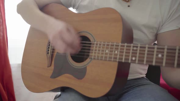 Closeup of a Man's Hands Playing the Guitar alt