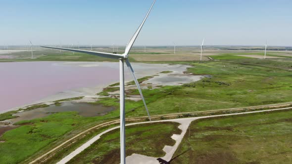 Contemporary Energy Generators Stand on Wind Farm By Lake